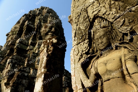 Stone Faces the Tempel Ruin of Angkor Thom in the Temple City of Angkor near the City of Siem Riep in the west of Cambodia.