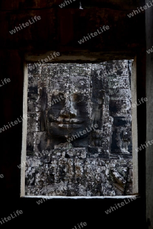 Stone Faces the Tempel Ruin of Angkor Thom in the Temple City of Angkor near the City of Siem Riep in the west of Cambodia.