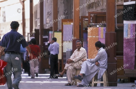 a shopping street in the souq or Market in the old town in the city of Dubai in the Arab Emirates in the Gulf of Arabia.