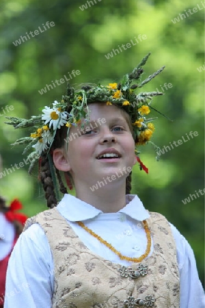 a Women in traditional dress on a Summer Festival in a Parc in the old City of Vilnius in the Baltic State of Lithuania,  