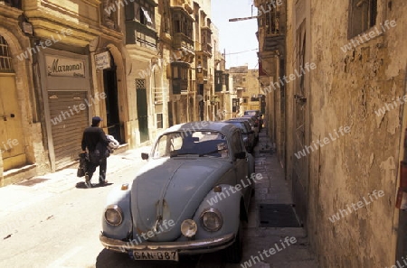 A smal road in the centre of the Old Town of the city of Valletta on the Island of Malta in the Mediterranean Sea in Europe.
