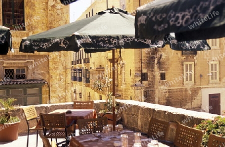 A smal road in the centre of the Old Town of the city of Valletta on the Island of Malta in the Mediterranean Sea in Europe.
