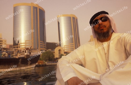 a city boat and ferry on the Dubai creek in the old town in the city of Dubai in the Arab Emirates in the Gulf of Arabia.