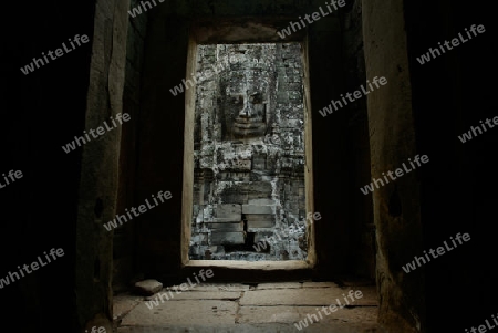 Stone Faces the Tempel Ruin of Angkor Thom in the Temple City of Angkor near the City of Siem Riep in the west of Cambodia.