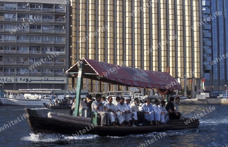 a city boat and ferry on the Dubai creek in the old town in the city of Dubai in the Arab Emirates in the Gulf of Arabia.