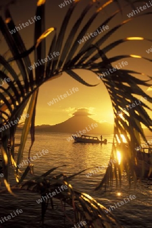 The Lake Atitlan mit the Volcanos of Toliman and San Pedro in the back at the Town of Panajachel in Guatemala in central America.   