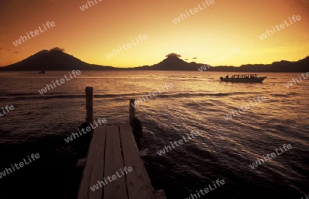 The Lake Atitlan mit the Volcanos of Toliman and San Pedro in the back at the Town of Panajachel in Guatemala in central America.   