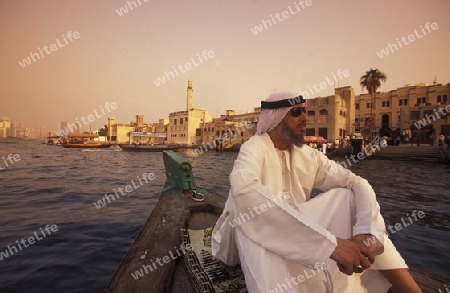 a city boat and ferry on the Dubai creek in the old town in the city of Dubai in the Arab Emirates in the Gulf of Arabia.