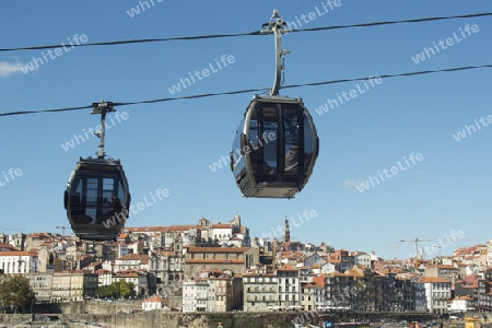 the cablecar and the old town on the Douro River in Ribeira in the city centre of Porto in Porugal in Europe.