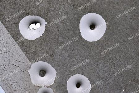 Detailed close up of bullet holes from gun shots in a german traffic sign