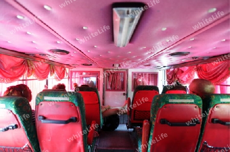 a overland bus in pink in the city of Bangkok in Thailand in Suedostasien.