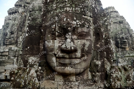 Stone Faces the Tempel Ruin of Angkor Thom in the Temple City of Angkor near the City of Siem Riep in the west of Cambodia.