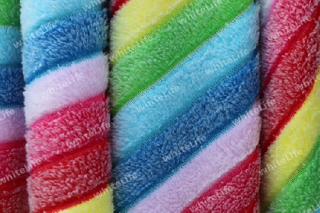 Detailed close up view on samples of cloth and fabrics in different colors found at a fabrics market.