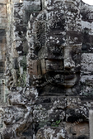 Stone Faces the Tempel Ruin of Angkor Thom in the Temple City of Angkor near the City of Siem Riep in the west of Cambodia.