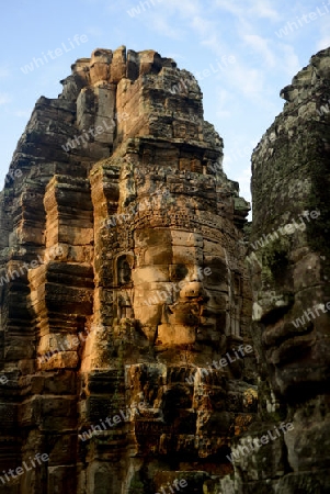 Stone Faces the Tempel Ruin of Angkor Thom in the Temple City of Angkor near the City of Siem Riep in the west of Cambodia.