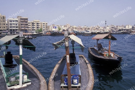 a city boat and ferry on the Dubai creek in the old town in the city of Dubai in the Arab Emirates in the Gulf of Arabia.