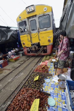 the Maeklong Railway Markt at the Maeklong railway station  near the city of Bangkok in Thailand in Suedostasien.