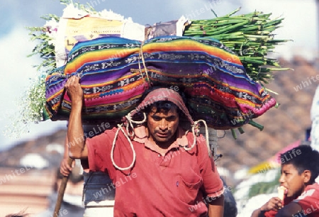 people in traditional clotes at the Market in the Village of  Chichi or Chichicastenango in Guatemala in central America.   