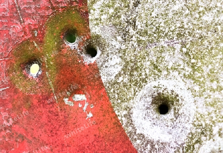 Detailed close up of bullet holes from gun shots in a german traffic sign