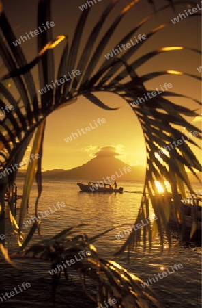 The Lake Atitlan mit the Volcanos of Toliman and San Pedro in the back at the Town of Panajachel in Guatemala in central America.   