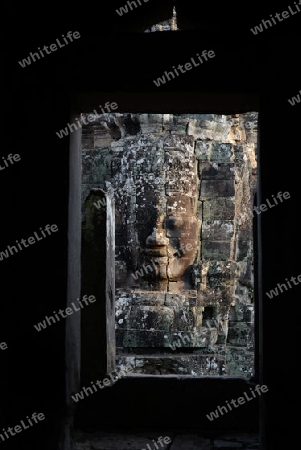 Stone Faces the Tempel Ruin of Angkor Thom in the Temple City of Angkor near the City of Siem Riep in the west of Cambodia.