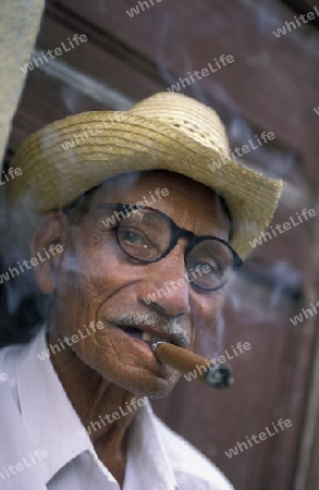 a signor with a cigar in the city of Santiago de Cuba on Cuba in the caribbean sea.