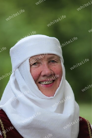 a Women in traditional dress on a Summer Festival in a Parc in the old City of Vilnius in the Baltic State of Lithuania,  