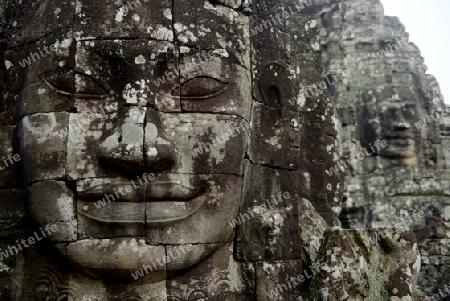 Stone Faces the Tempel Ruin of Angkor Thom in the Temple City of Angkor near the City of Siem Riep in the west of Cambodia.