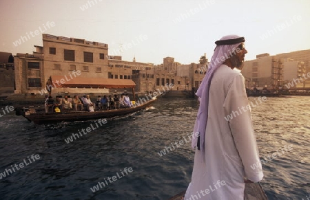 a city boat and ferry on the Dubai creek in the old town in the city of Dubai in the Arab Emirates in the Gulf of Arabia.