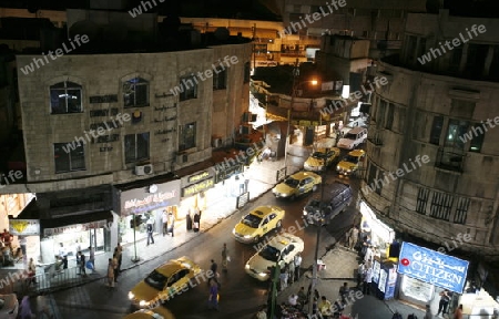 a road in the city centre at night in the City Amman in Jordan in the middle east.