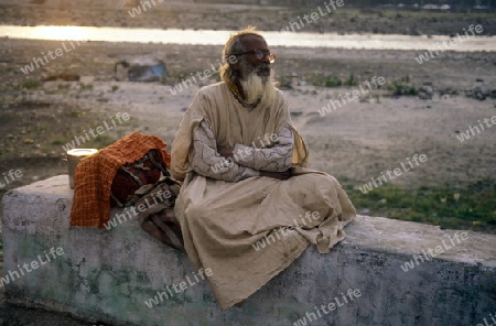 a men on the Ganges River in the town of Rishikesh in the Province Uttar Pradesh in India.