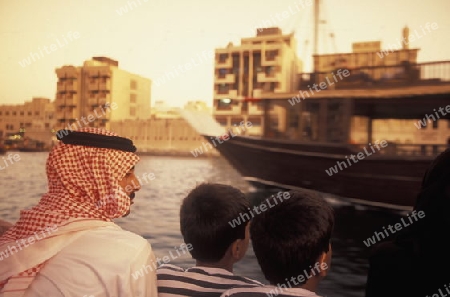 a city boat and ferry on the Dubai creek in the old town in the city of Dubai in the Arab Emirates in the Gulf of Arabia.