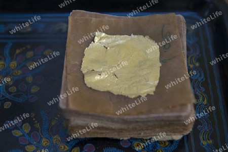 sheets of Gold leaf at a Gold pounder Factory the City of Mandalay in Myanmar in Southeastasia.