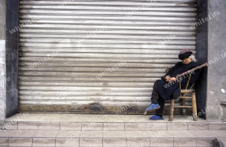 a old women in the city of Shenzhen north of Hongkong in the province of Guangdong in china in east asia. 