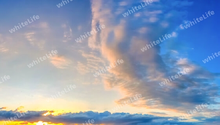 Beautiful high resolution panorama of orange and red sunset clouds in the evening sky.