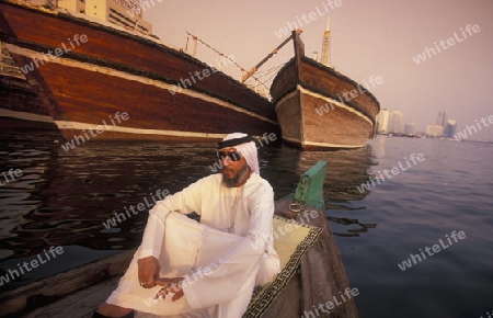 a city boat and ferry on the Dubai creek in the old town in the city of Dubai in the Arab Emirates in the Gulf of Arabia.