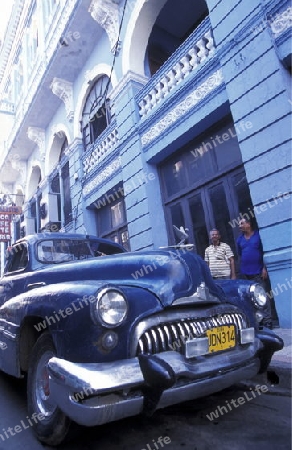 a old car in the in the city centre in the city of Santiago de Cuba on Cuba in the caribbean sea.