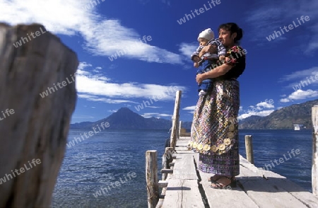 People at the coast of Lake Atitlan mit the Volcanos of Toliman and San Pedro in the back at the Town of Panajachel in Guatemala in central America.   