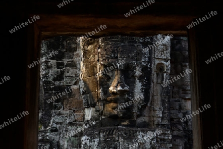 Stone Faces the Tempel Ruin of Angkor Thom in the Temple City of Angkor near the City of Siem Riep in the west of Cambodia.