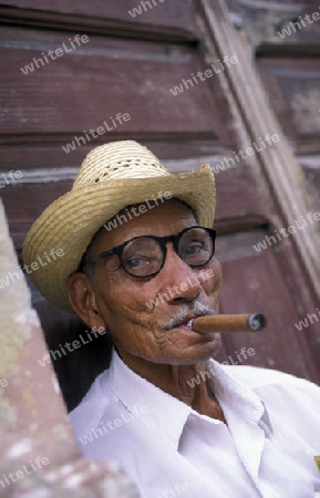 a signor with a cigar in the city of Santiago de Cuba on Cuba in the caribbean sea.