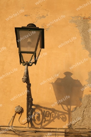 a lamp with shadow in the old Town of Siracusa in Sicily in south Italy in Europe.