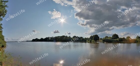 Beautiful high resolution panorama of a northern european country landscape with fields and green grass.