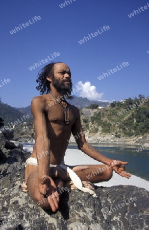 a men on the Ganges River in the town of Rishikesh in the Province Uttar Pradesh in India.