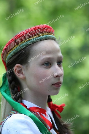 a Women in traditional dress on a Summer Festival in a Parc in the old City of Vilnius in the Baltic State of Lithuania,  