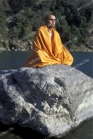 a men on the Ganges River in the town of Rishikesh in the Province Uttar Pradesh in India.