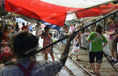 the Maeklong Railway Markt at the Maeklong railway station  near the city of Bangkok in Thailand in Suedostasien.