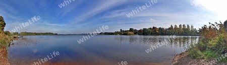 Beautiful high resolution panorama of a northern european country landscape with fields and green grass.