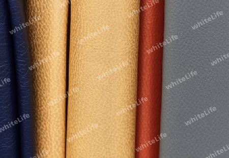 Detailed close up view on samples of cloth and fabrics in different colors found at a fabrics market.