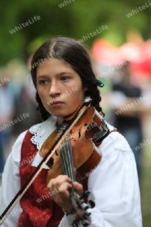 a Women in traditional dress on a Summer Festival in a Parc in the old City of Vilnius in the Baltic State of Lithuania,  