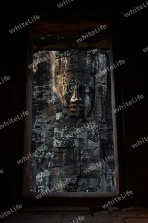 Stone Faces the Tempel Ruin of Angkor Thom in the Temple City of Angkor near the City of Siem Riep in the west of Cambodia.